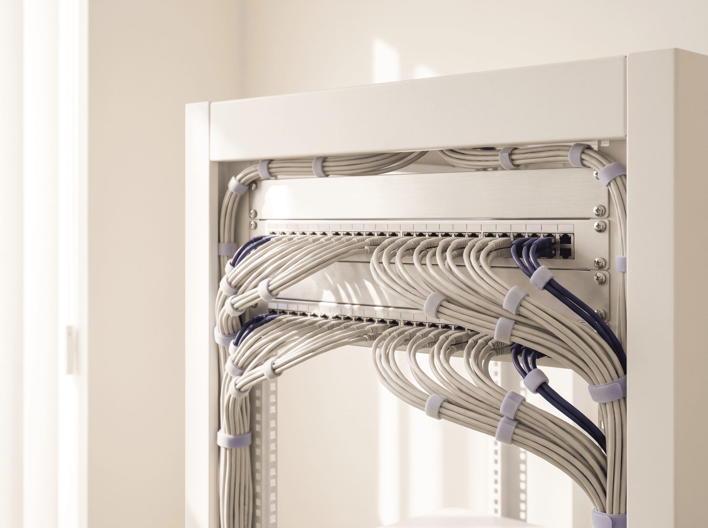Neat patch panel with pale gray and indigo cables