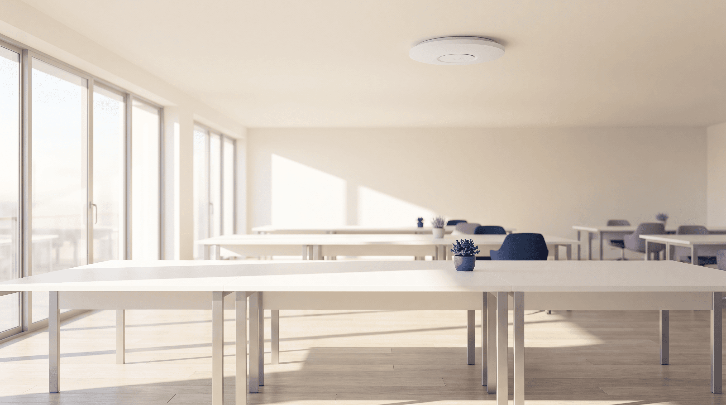 Bright modern office with a wireless access point on the ceiling