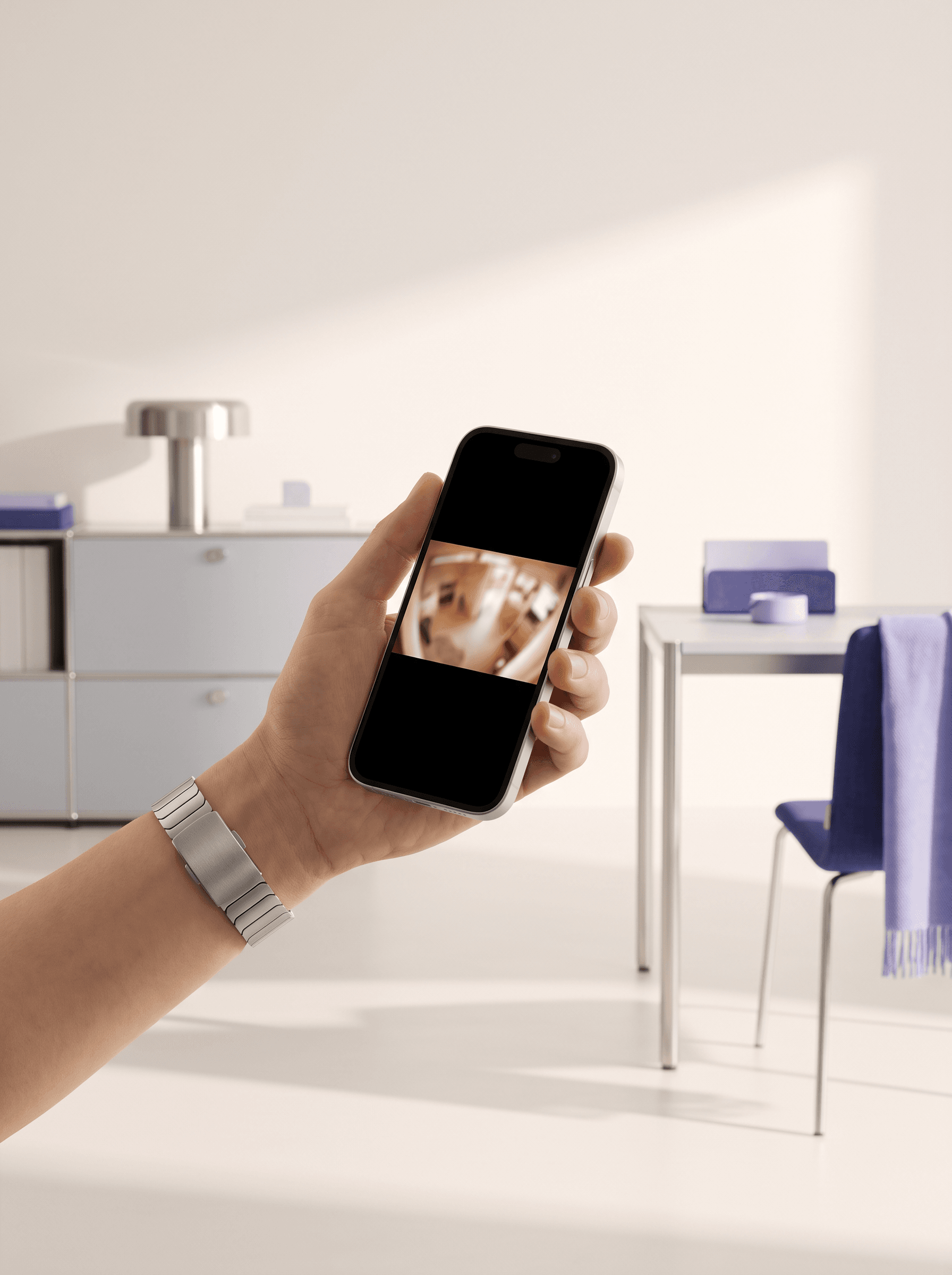 Hand holding a phone showing a live camera view